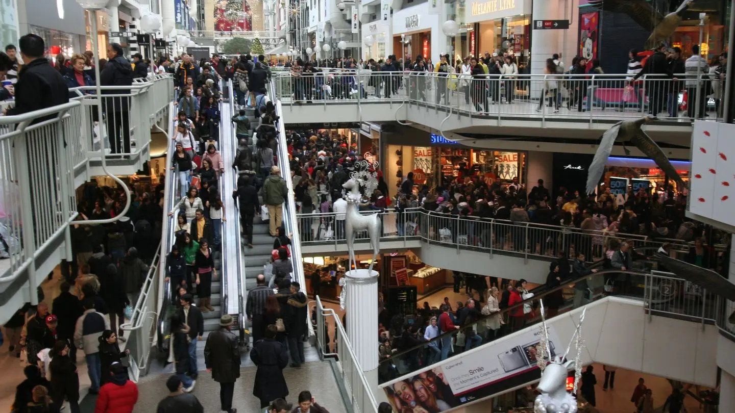 Shoppers crowding the escalators and walkways of the Toronto Eaton Centre