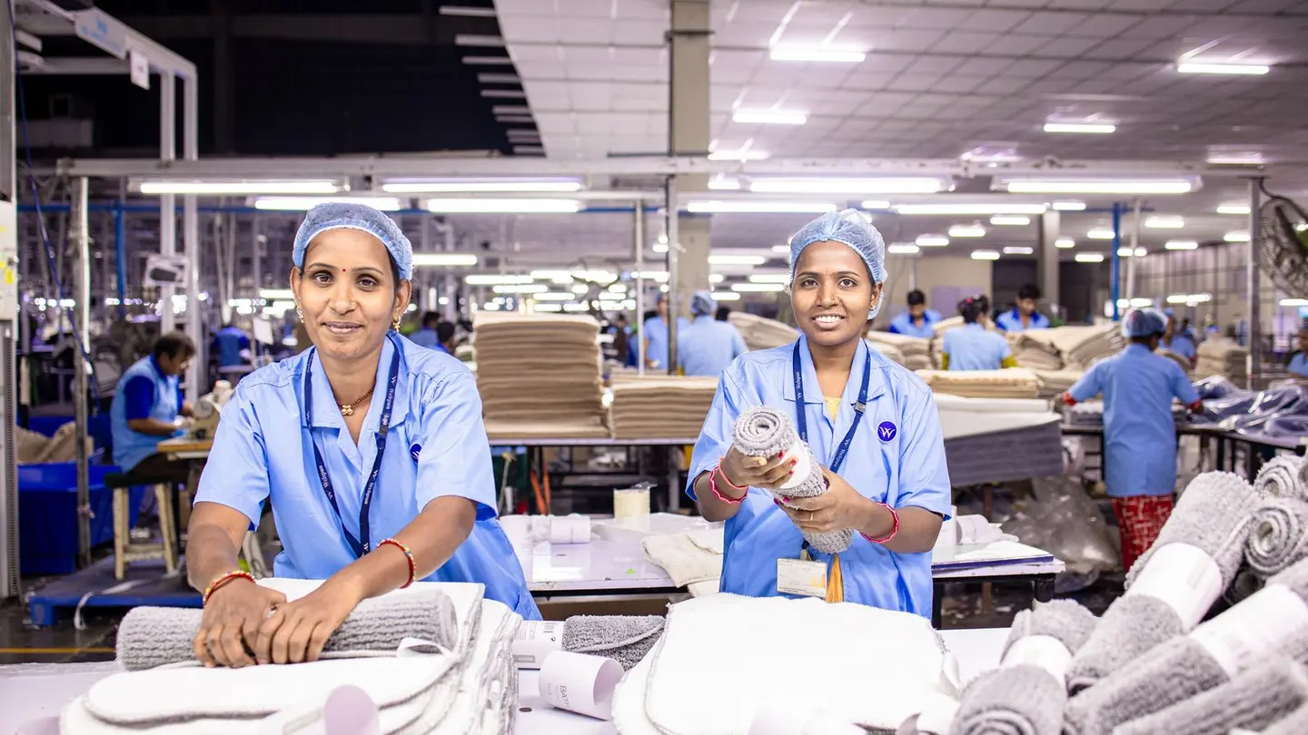 Female textile workers in factory setting.