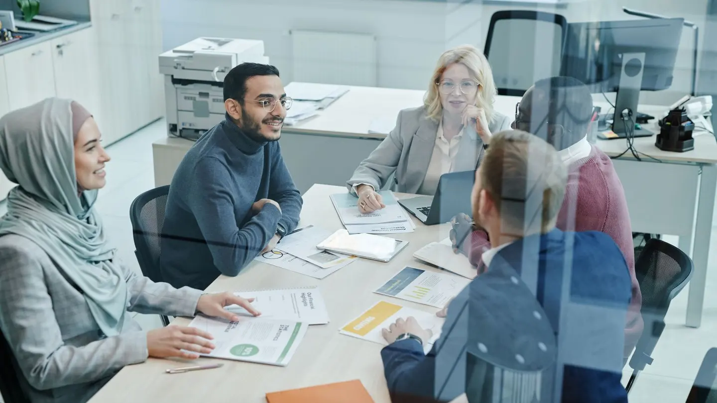 Employees having a meeting inside the company.