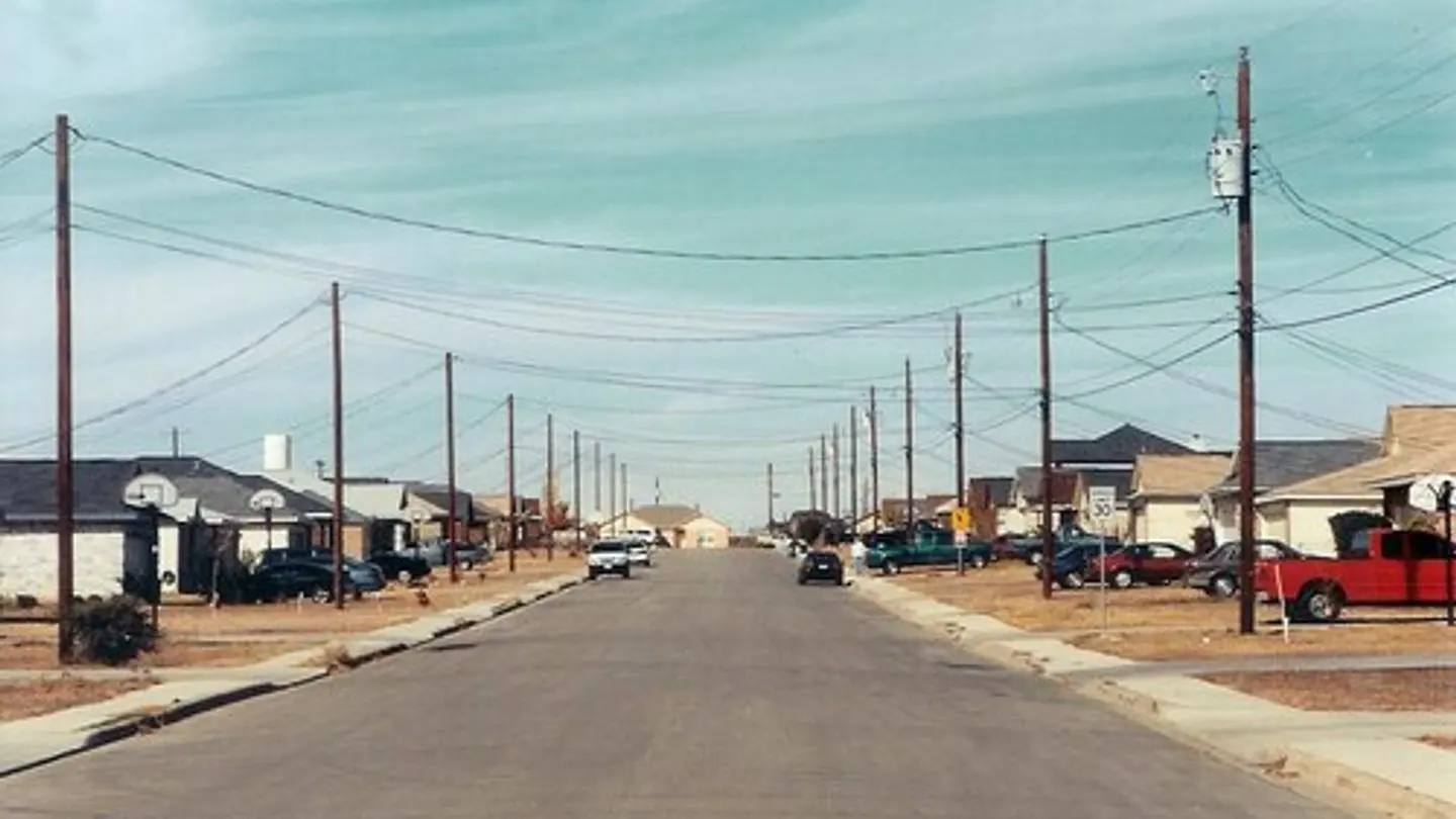 A suburban residential street in the United States lined with detached houses